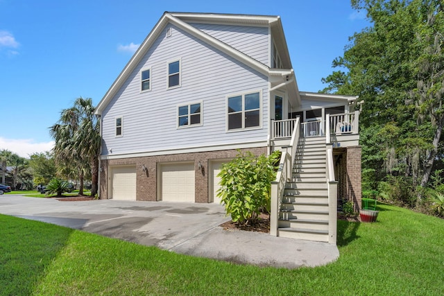 8605 Refuge Point Cir N, Charleston, SC 29420 - view of side of home featuring a yard, an attached garage, driveway, brick siding, and stairway