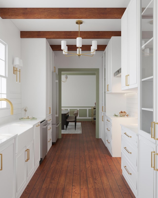 kitchen featuring stainless steel dishwasher, a chandelier, beamed ceiling, light countertops, and white cabinets