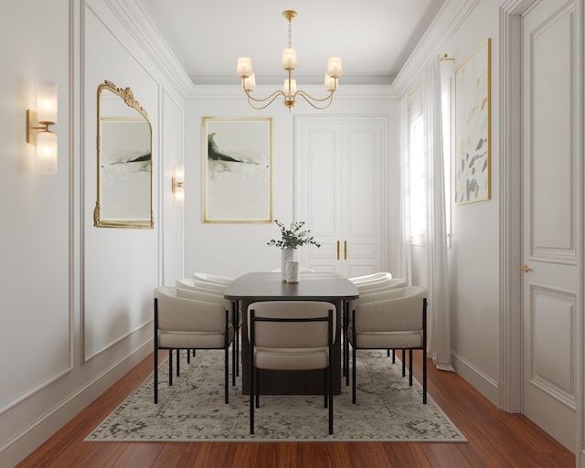 dining room with an inviting chandelier, crown molding, and wood finished floors