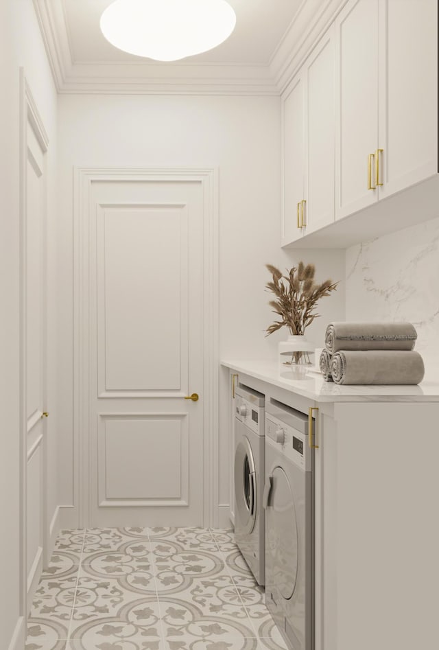 laundry area with light tile patterned floors, ornamental molding, washing machine and dryer, and cabinet space