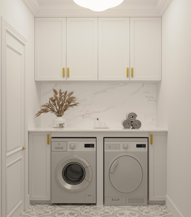 laundry room with baseboards, washer and dryer, light tile patterned flooring, and cabinet space