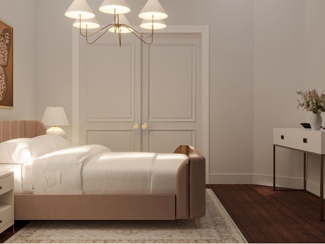bedroom featuring a chandelier, baseboards, and wood finished floors