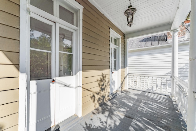 wooden terrace featuring covered porch