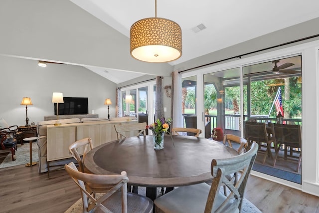 dining room with lofted ceiling and hardwood / wood-style flooring