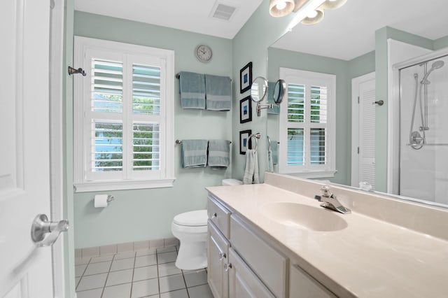 bathroom featuring vanity, toilet, a shower with shower door, and tile patterned flooring