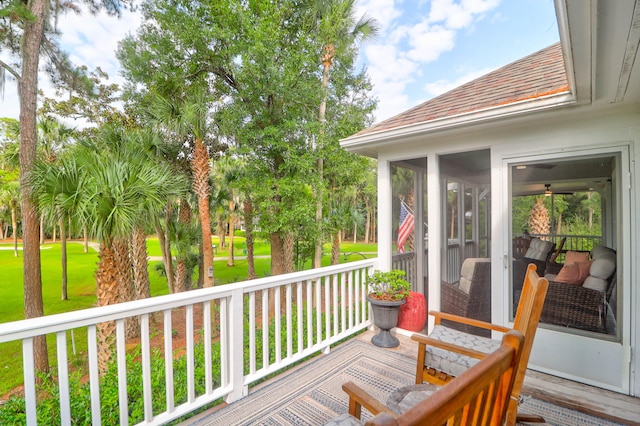 wooden deck featuring a yard and a sunroom