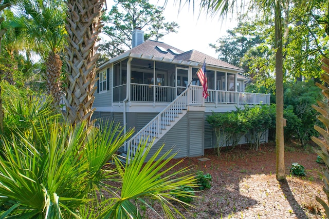 back of house with a sunroom