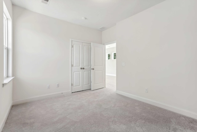 spare room with light colored carpet