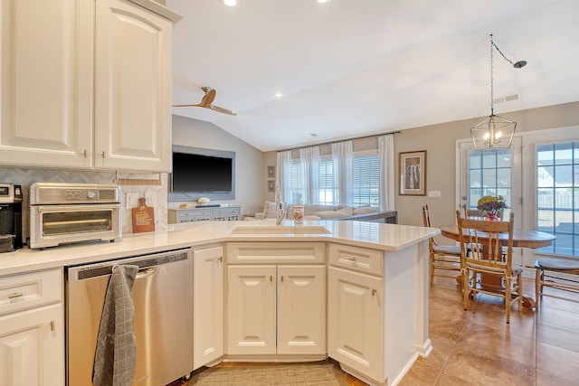 kitchen with stainless steel dishwasher, plenty of natural light, sink, and tasteful backsplash