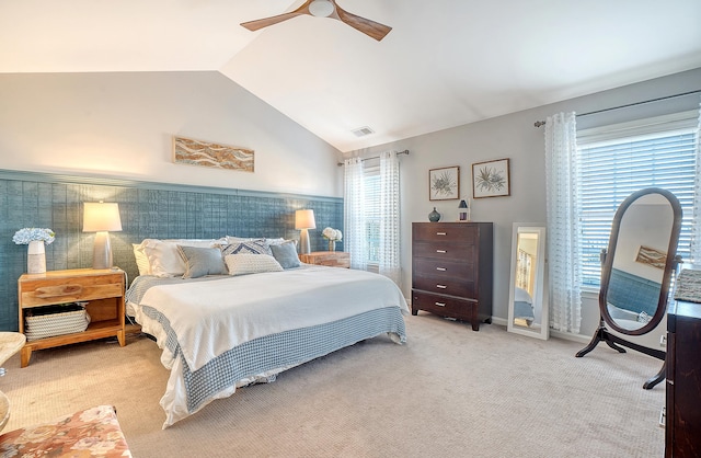 bedroom featuring light carpet, vaulted ceiling, and ceiling fan