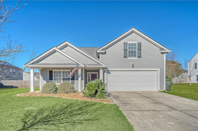 view of property featuring a garage and a front lawn