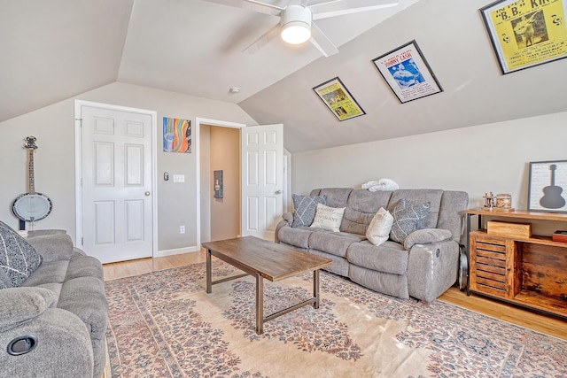 living room featuring ceiling fan, lofted ceiling, and hardwood / wood-style flooring