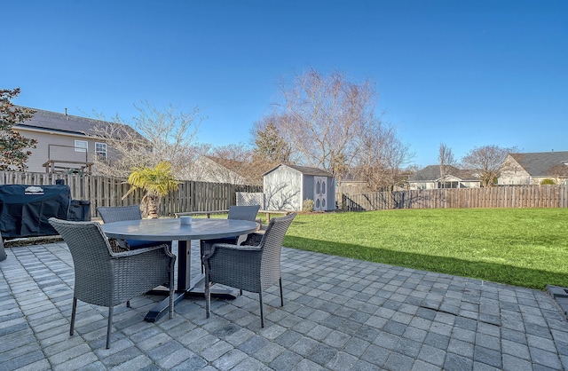 view of patio with a storage unit and grilling area