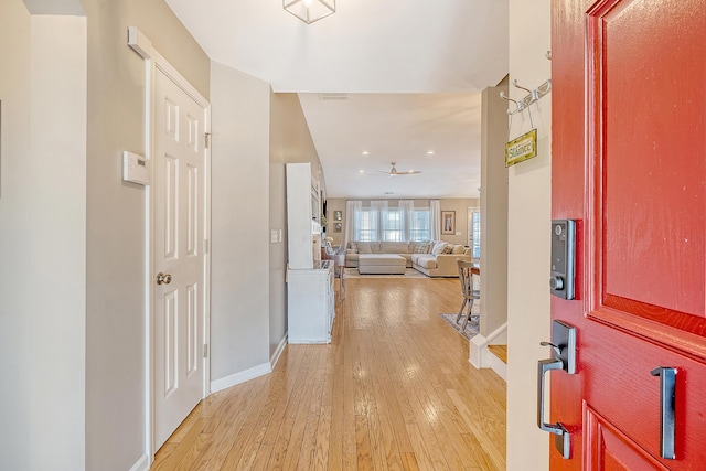 foyer entrance with light wood-type flooring and ceiling fan