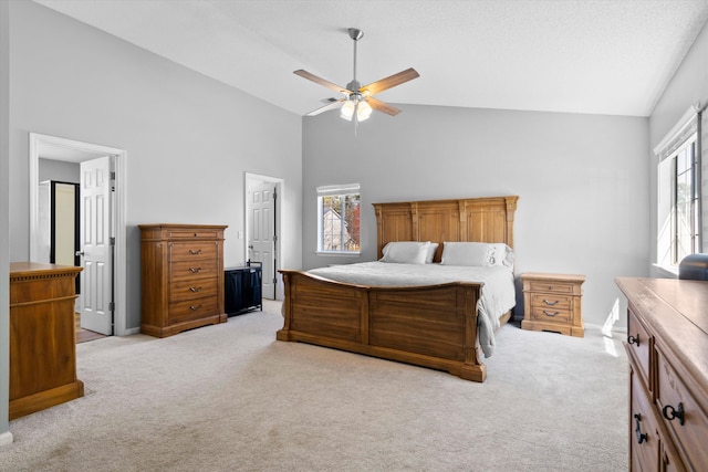 bedroom featuring multiple windows, light colored carpet, ceiling fan, and high vaulted ceiling