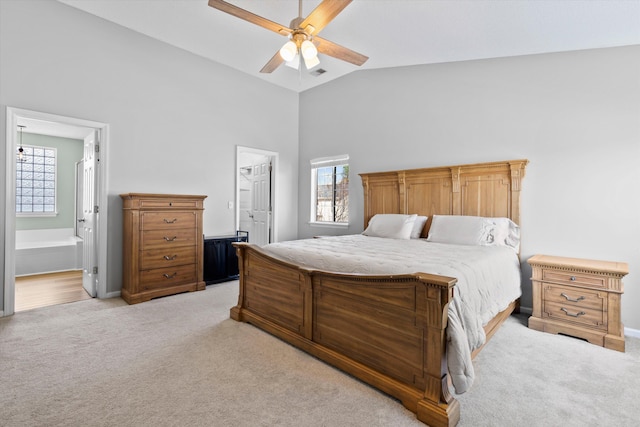 bedroom featuring light carpet, visible vents, ensuite bath, and ceiling fan