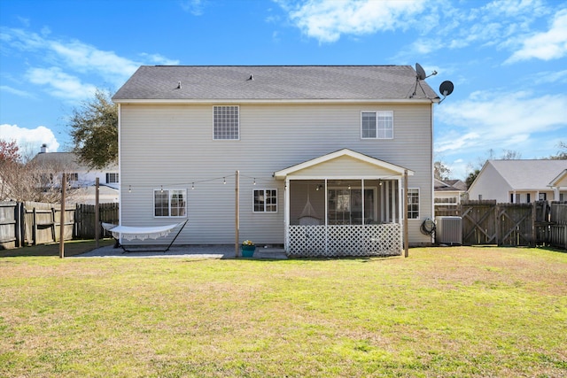 back of property featuring a yard, a patio area, a fenced backyard, and a sunroom