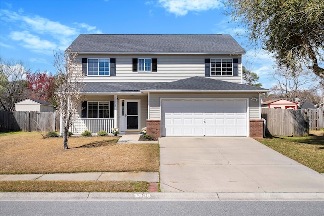 traditional-style home featuring brick siding, driveway, and fence