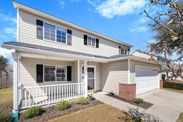 traditional home with an attached garage, covered porch, and driveway