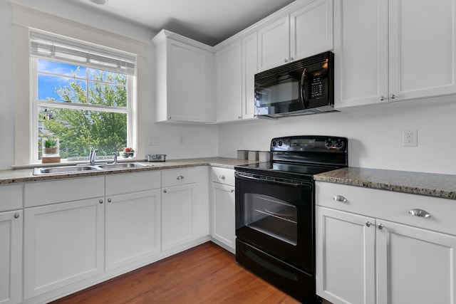 2405 Louisville St, Charleston, SC 29492 - kitchen featuring white cabinetry, black appliances, light stone countertops, light wood-style floors, and a sink