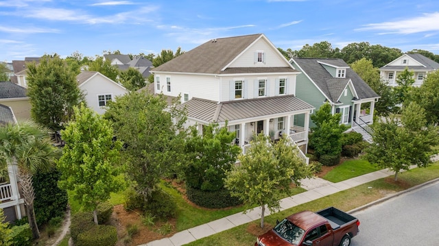 2405 Louisville St, Charleston, SC 29492 - view of front of property featuring a standing seam roof, metal roof, a shingled roof, and covered porch