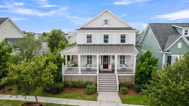 2405 Louisville St, Charleston, SC 29492 - view of front of home with a standing seam roof, covered porch, stairs, and metal roof