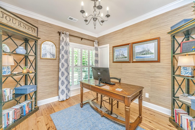 office space featuring crown molding, an inviting chandelier, baseboards, wood finished floors, and visible vents