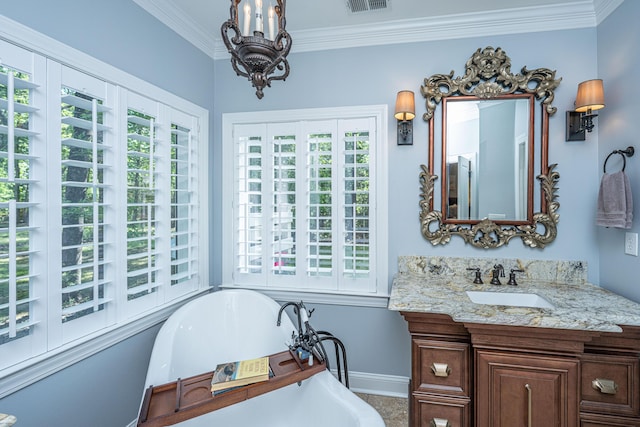 full bath with crown molding, an inviting chandelier, vanity, baseboards, and a freestanding bath