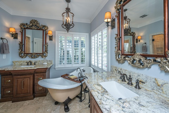 bathroom with a freestanding tub, visible vents, two vanities, and a sink