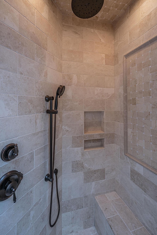 interior details featuring tiled shower
