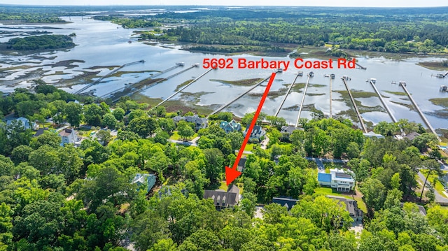 aerial view with a water view and a forest view