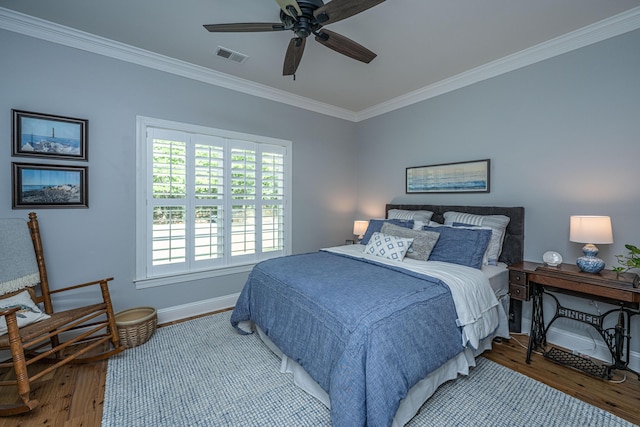 bedroom featuring baseboards, visible vents, ornamental molding, and light wood-style floors