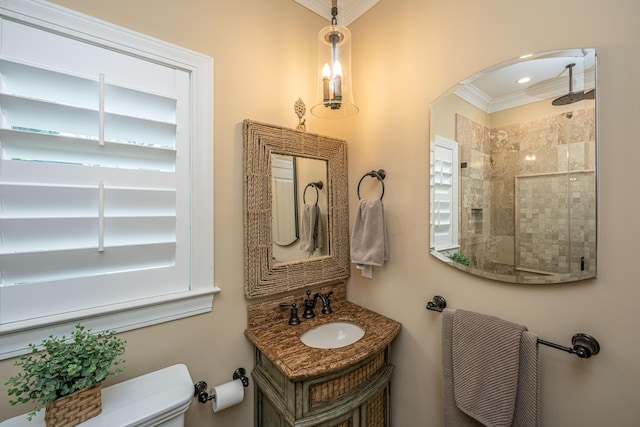bathroom featuring vanity, ornamental molding, toilet, and tiled shower