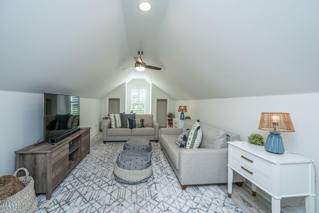 living area featuring ceiling fan and lofted ceiling