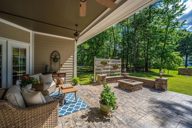 view of patio with a ceiling fan and an outdoor fire pit