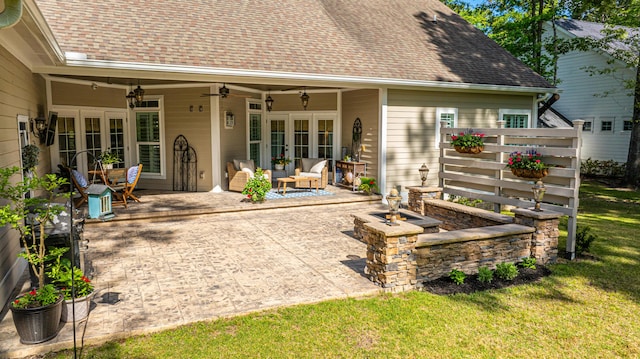 back of house with a ceiling fan, french doors, a lawn, a patio area, and a shingled roof