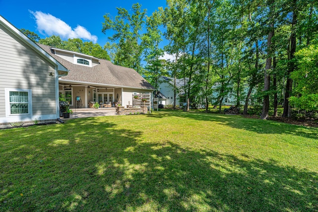 view of yard featuring a ceiling fan and a patio area