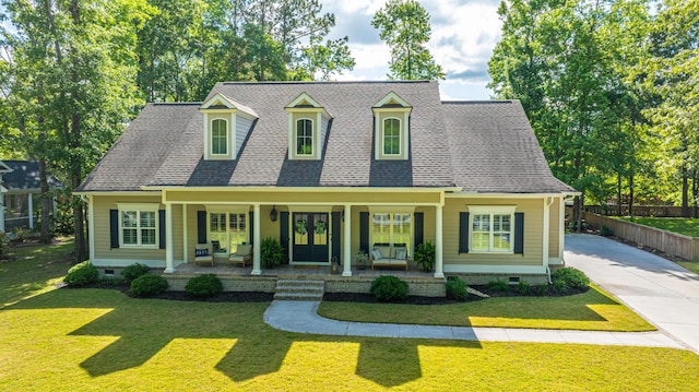 cape cod-style house with a porch, crawl space, a front yard, roof with shingles, and fence