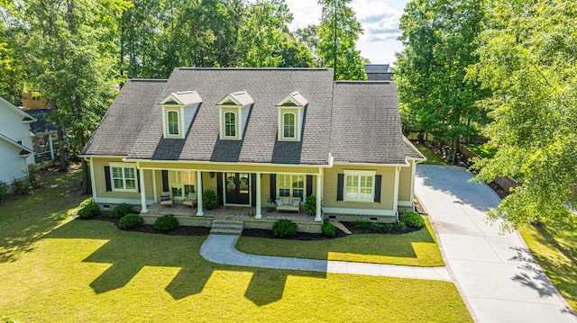 cape cod house featuring a front lawn, french doors, crawl space, concrete driveway, and a porch