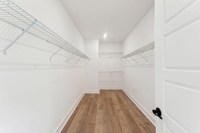 spacious closet with light hardwood / wood-style flooring