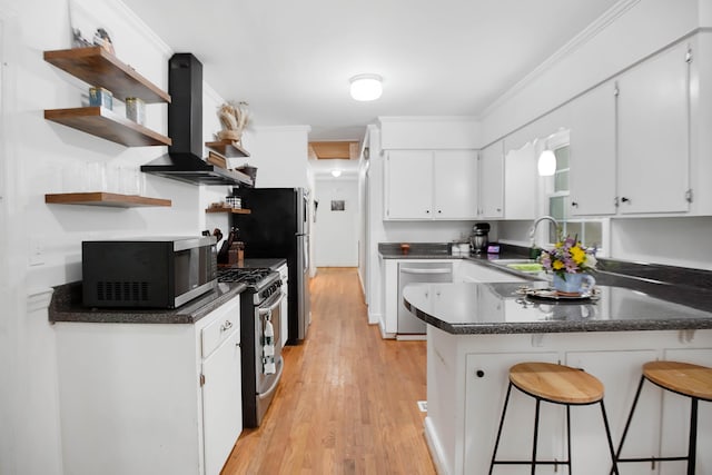 113 Overhill Dr, Walterboro, SC 29488 - kitchen featuring stainless steel appliances, wall chimney exhaust hood, open shelves, a peninsula, and light wood finished floors