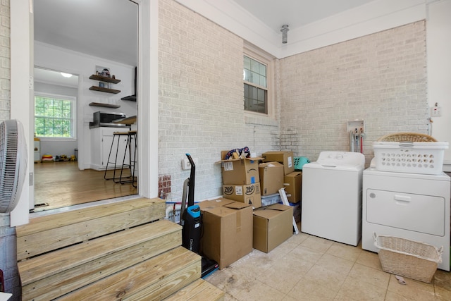113 Overhill Dr, Walterboro, SC 29488 - washroom with washing machine and clothes dryer, brick wall, and light tile patterned flooring