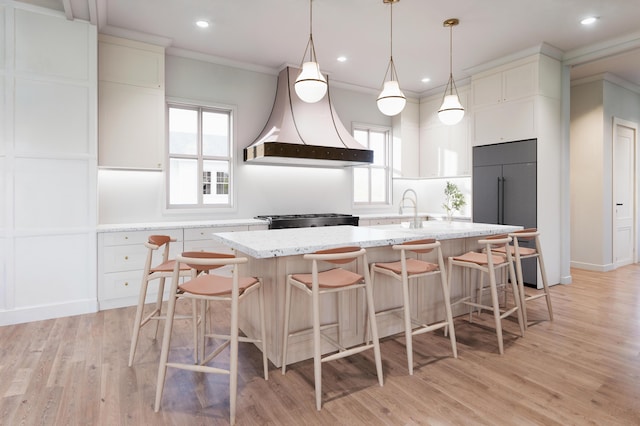 814 Palm Blvd, Isle Of Palms, SC 29451 - kitchen featuring premium range hood, range, plenty of natural light, an island with sink, and recessed lighting