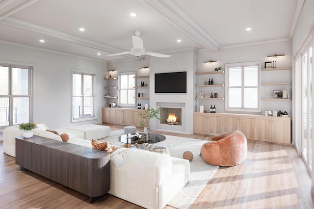 814 Palm Blvd, Isle Of Palms, SC 29451 - living area featuring crown molding, beamed ceiling, a fireplace, light wood finished floors, and a ceiling fan
