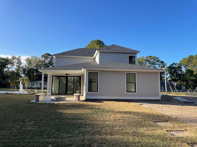 rear view of house with a patio area and a lawn