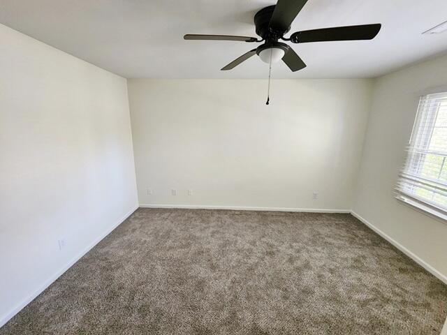 carpeted empty room featuring ceiling fan