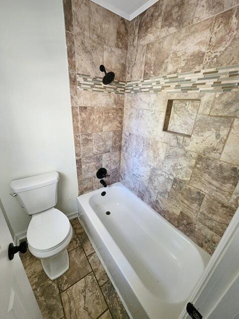 bathroom with tiled shower / bath combo, toilet, and ornamental molding