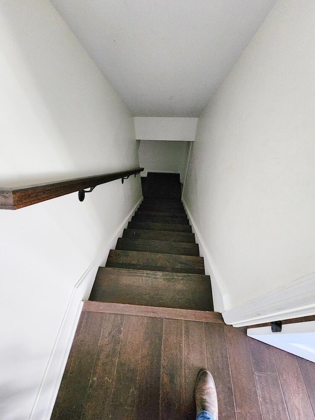 stairs with lofted ceiling and wood-type flooring