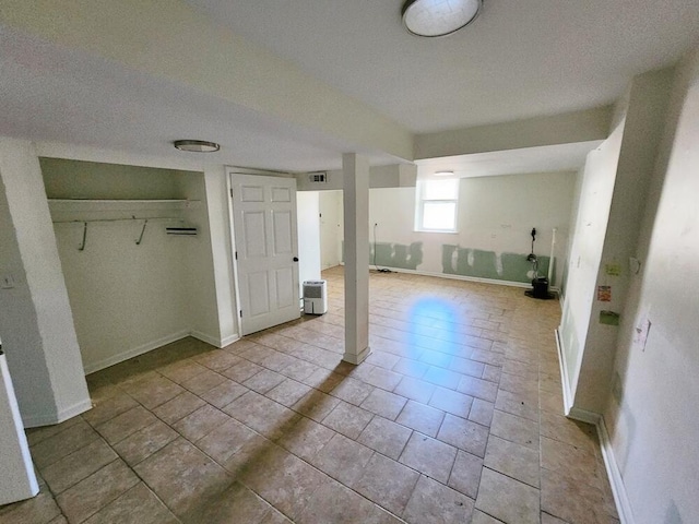 interior space with light tile patterned floors and a textured ceiling