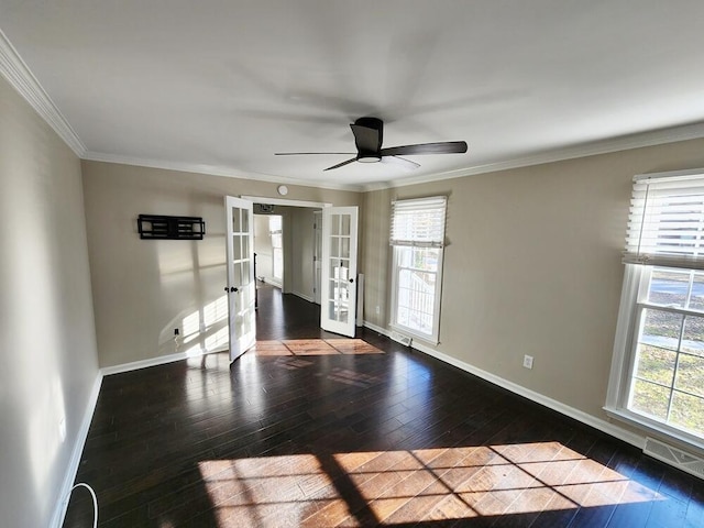 unfurnished room featuring dark hardwood / wood-style floors, a healthy amount of sunlight, and french doors